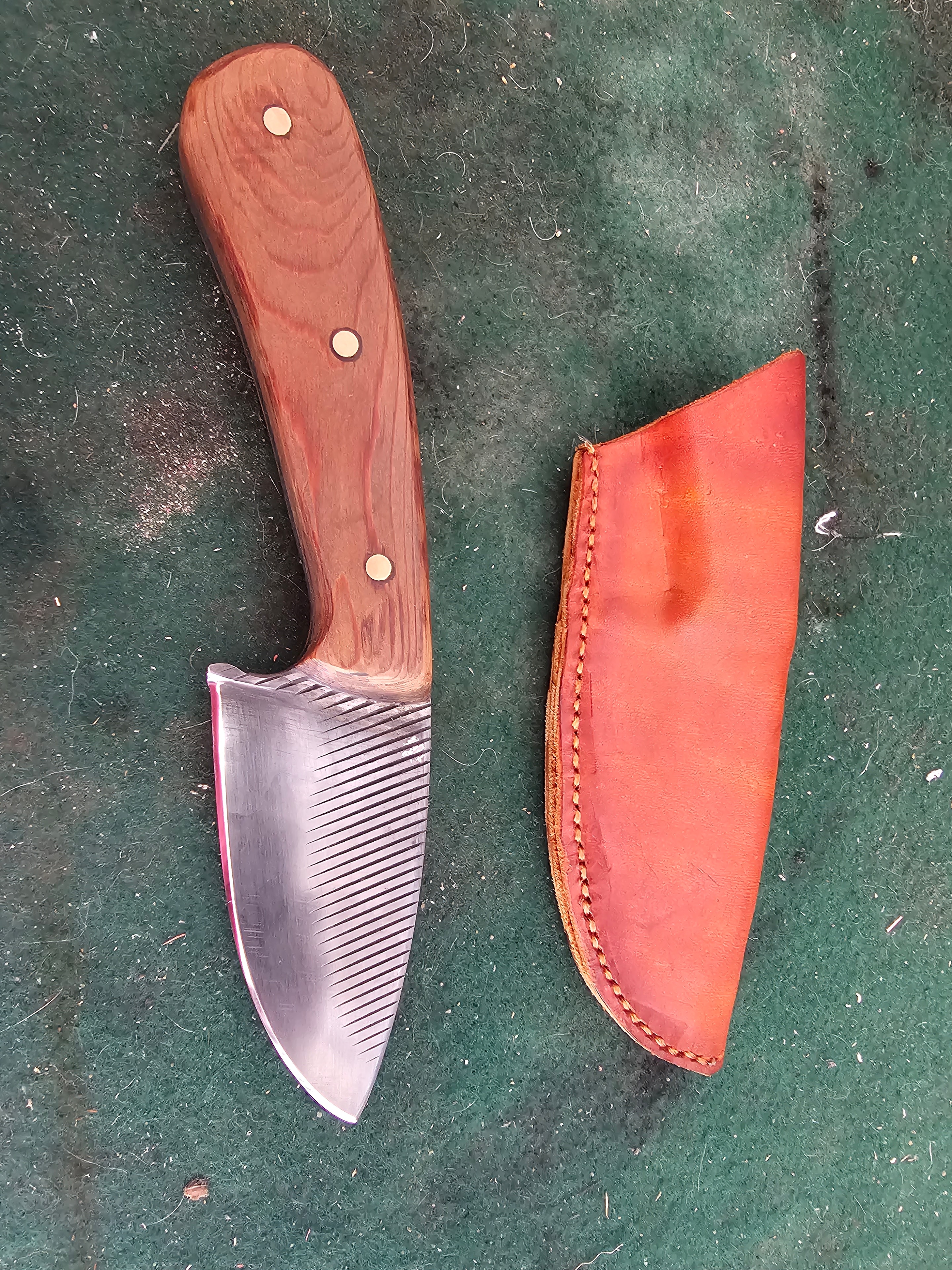Handcrafted knife with wood handle and red leather sheath