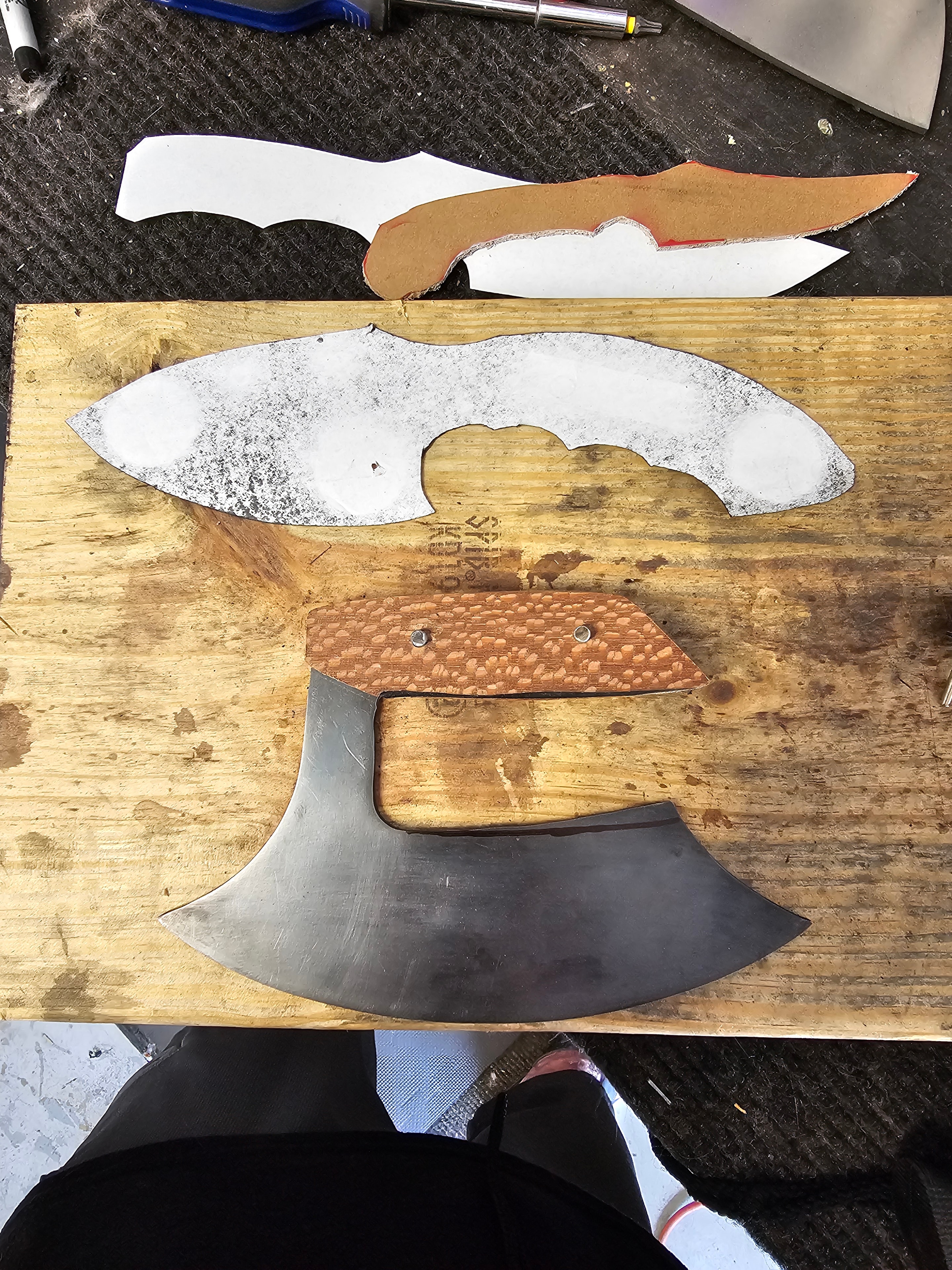 Ulu knife and cleaver blade templates and handles in progress on workbench