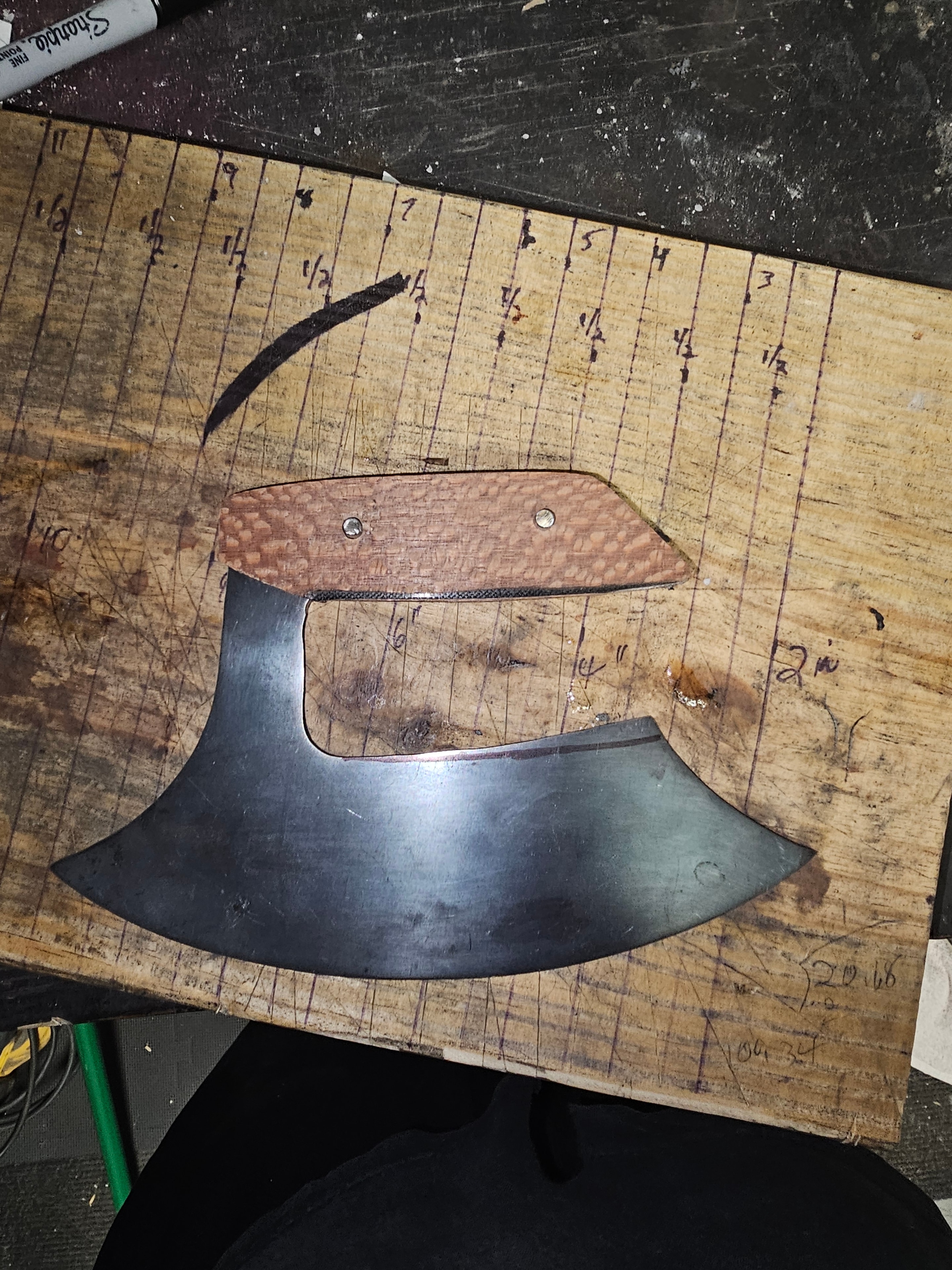 Ulu knife with snake skin textured handle on measurement board