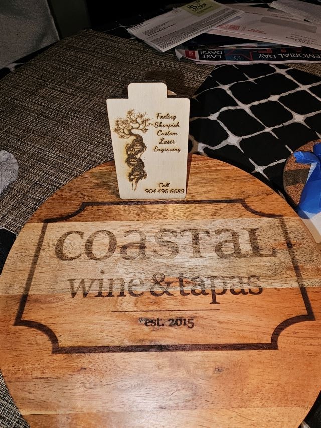 Coastal Wine & Tapas sign with Feeling Sharpish business card