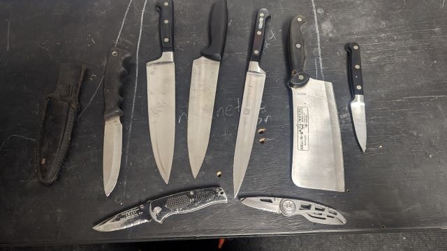 Collection of kitchen knives and folding knives for sharpening
